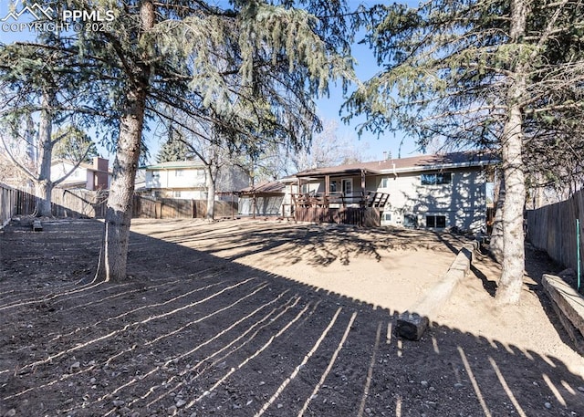 exterior space with a fenced backyard and a deck