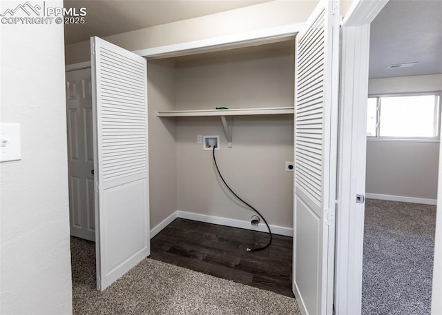 clothes washing area featuring dark wood-type flooring, washer hookup, laundry area, and baseboards