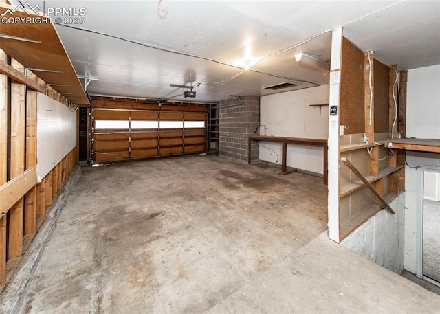 garage featuring a workshop area and a garage door opener