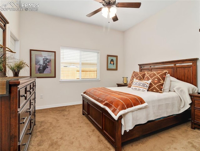 bedroom featuring light carpet, baseboards, and a ceiling fan