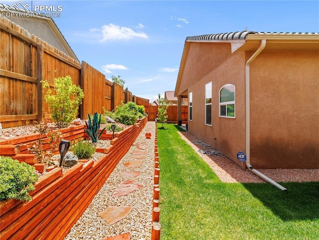 view of yard featuring a fenced backyard and a vegetable garden