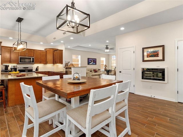 dining room featuring baseboards, wood finish floors, a ceiling fan, and recessed lighting