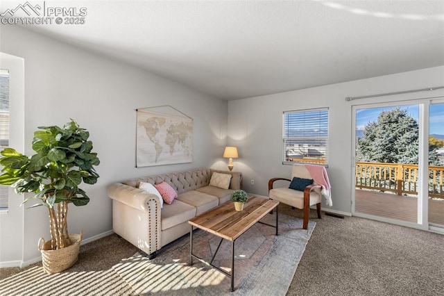 carpeted living room featuring visible vents and baseboards