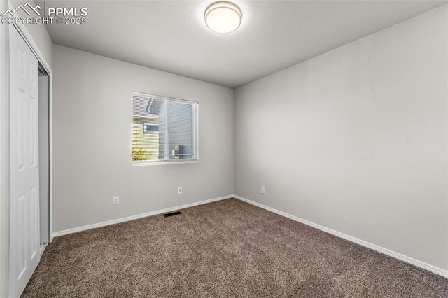 unfurnished bedroom with carpet floors, a closet, visible vents, and baseboards