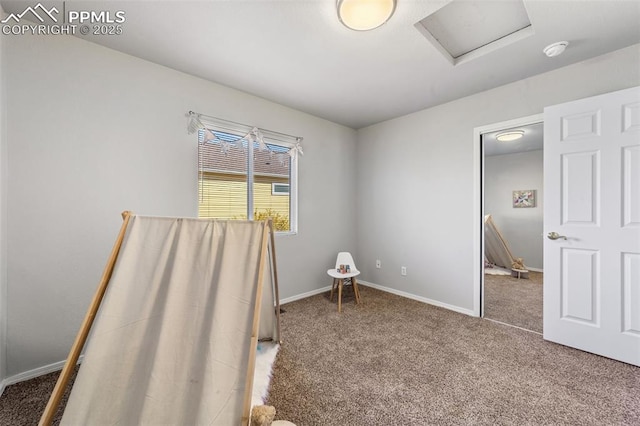 interior space featuring attic access, carpet flooring, and baseboards