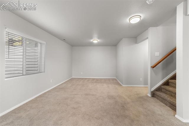 unfurnished room featuring stairs, carpet, and baseboards