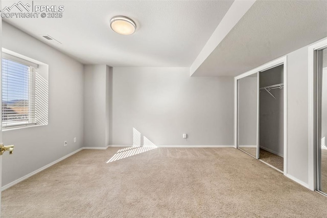 unfurnished bedroom featuring carpet floors and baseboards