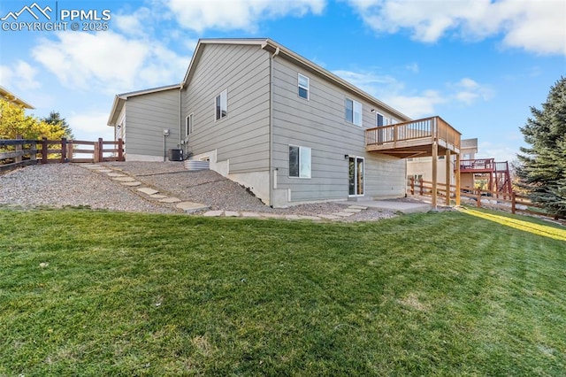 back of property featuring a patio, cooling unit, fence, a yard, and a wooden deck