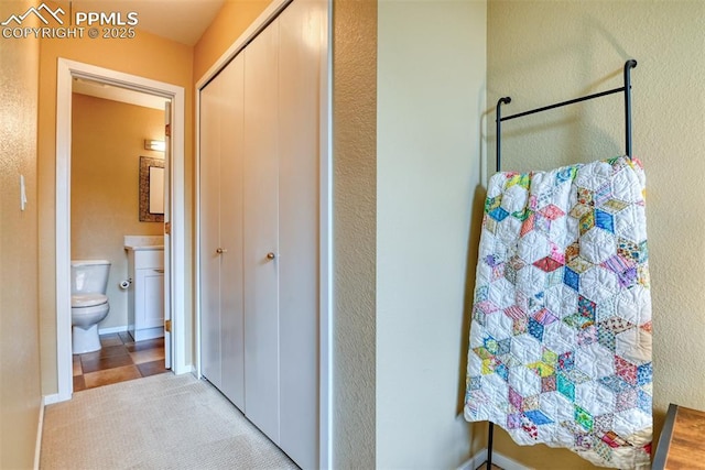 bathroom featuring toilet, baseboards, and vanity