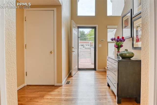 entrance foyer featuring light wood-style floors, baseboards, and visible vents