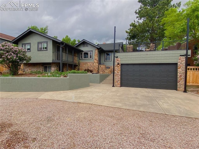 view of front of house with concrete driveway and stone siding