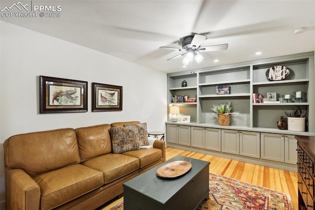 living room featuring ceiling fan, light wood finished floors, and recessed lighting