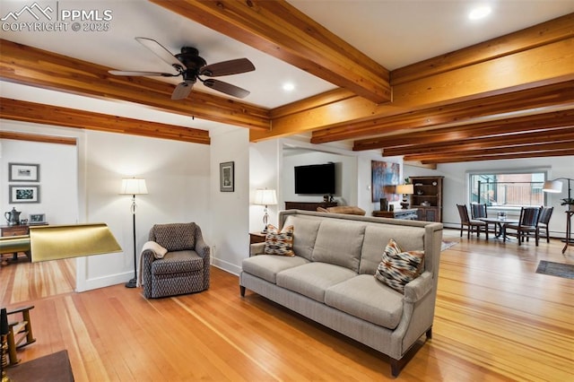 living area featuring hardwood / wood-style flooring, beamed ceiling, a ceiling fan, recessed lighting, and baseboards
