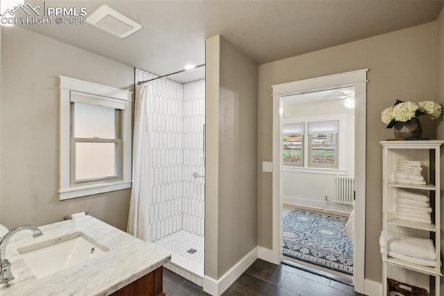 full bath with radiator, a shower stall, plenty of natural light, and baseboards