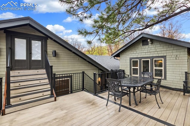 wooden deck with outdoor dining area, french doors, and entry steps