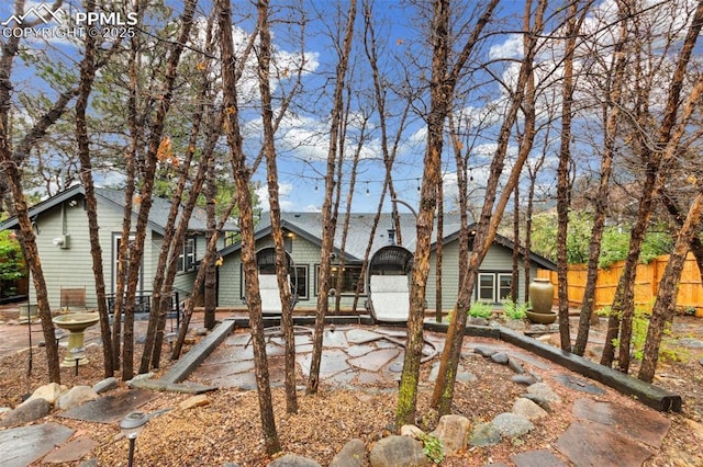 back of house featuring fence