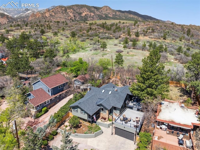 aerial view of property and surrounding area with a mountainous background