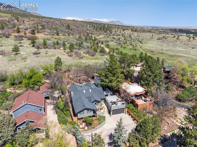 aerial view of property and surrounding area with a mountainous background