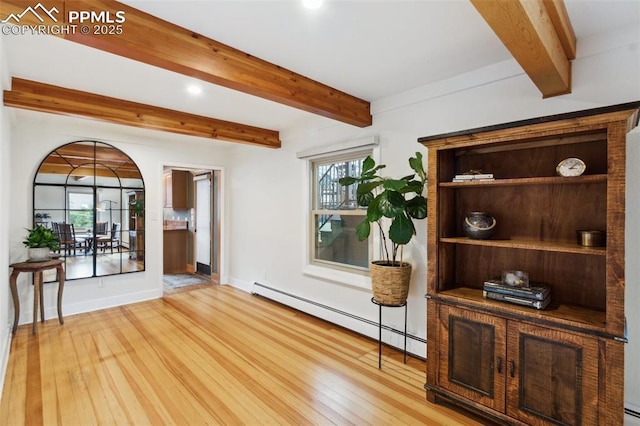 unfurnished room with baseboard heating, light wood-style flooring, beamed ceiling, healthy amount of natural light, and recessed lighting