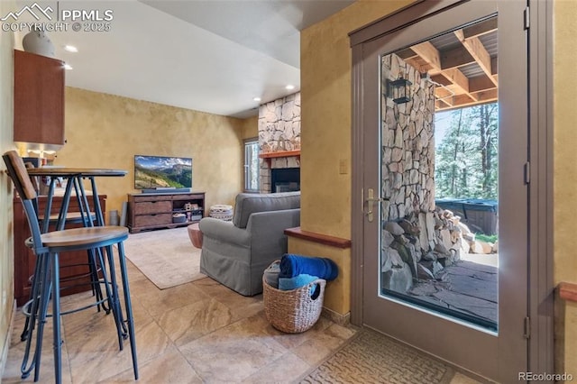 living room with a fireplace and recessed lighting