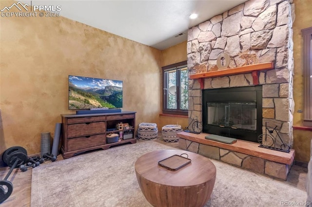 carpeted living room featuring visible vents and a fireplace