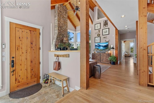 foyer entrance with ceiling fan, high vaulted ceiling, wood finished floors, beamed ceiling, and ornate columns