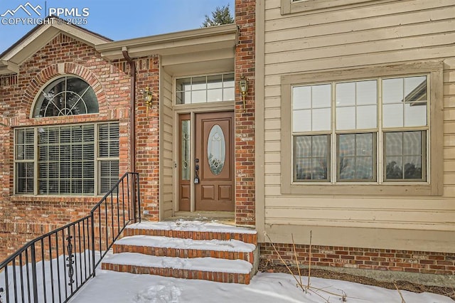 view of snow covered property entrance