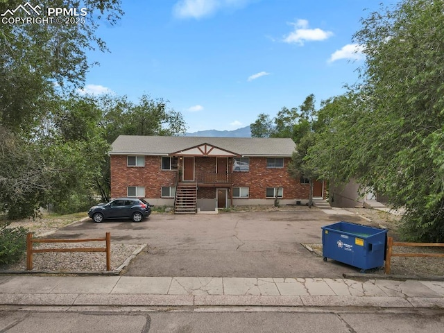 1073 Westmoreland Rd, Colorado Springs, CO 80907 - townhome / multi-family property featuring stairs, fence, and brick siding