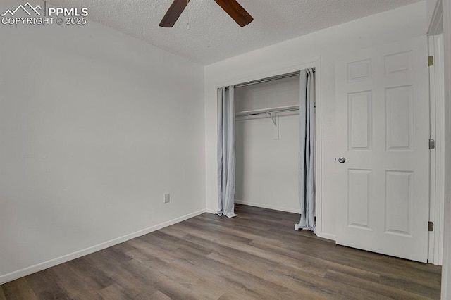 1073 Westmoreland Rd, Colorado Springs, CO 80907 - unfurnished bedroom with baseboards, dark wood-style floors, ceiling fan, a textured ceiling, and a closet