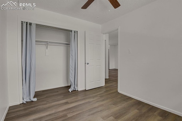 1073 Westmoreland Rd, Colorado Springs, CO 80907 - unfurnished bedroom with a textured ceiling, a closet, wood finished floors, and a ceiling fan