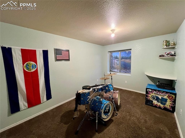 playroom featuring a textured ceiling, carpet floors, and baseboards