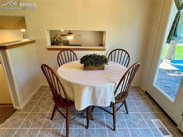 tiled dining area with visible vents and baseboards