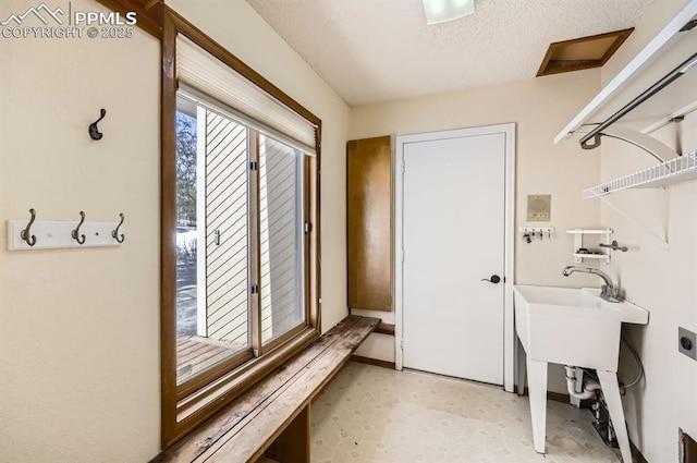 washroom with laundry area, a textured ceiling, electric dryer hookup, and light floors