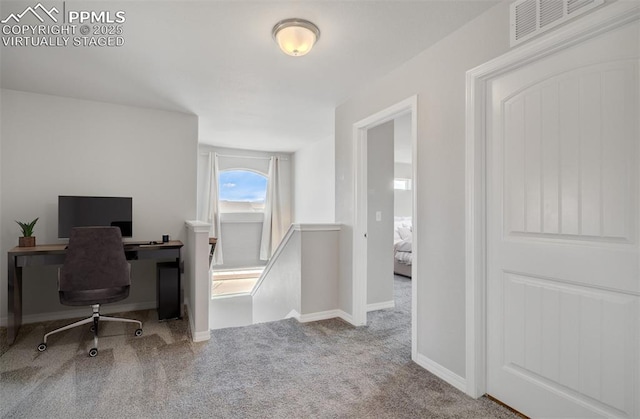 home office with carpet floors, visible vents, and baseboards