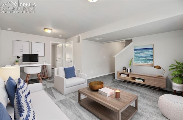 living area featuring baseboards, visible vents, and carpet flooring