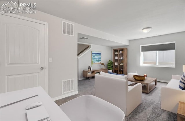 living room featuring baseboards, visible vents, and carpet flooring