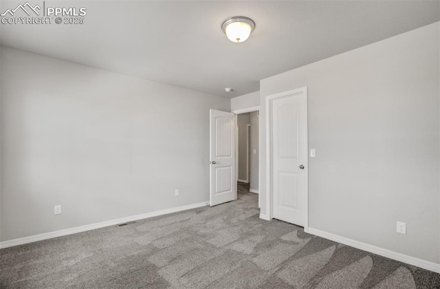 unfurnished bedroom featuring carpet flooring and baseboards