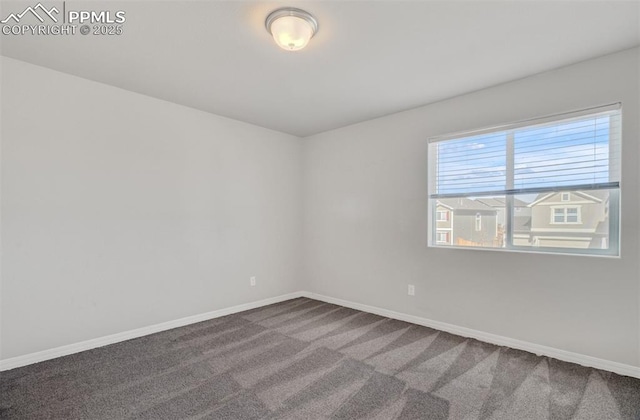 carpeted spare room with baseboards