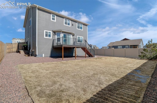 rear view of house featuring a fenced backyard, stairs, and a wooden deck