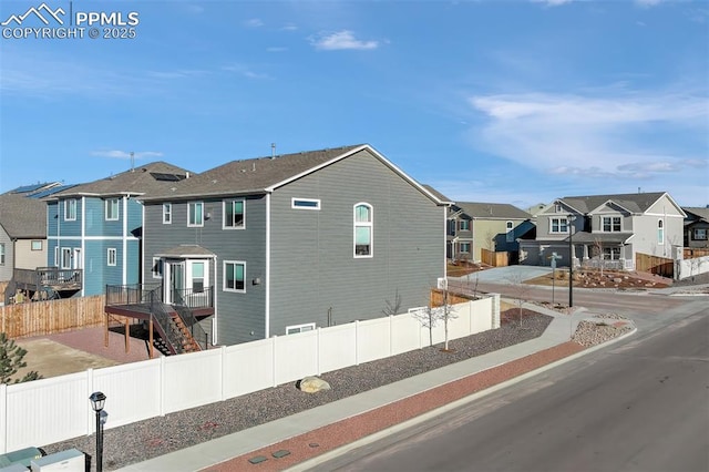 exterior space featuring a fenced backyard and a residential view