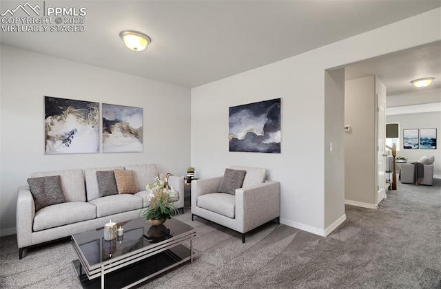 carpeted living area with baseboards