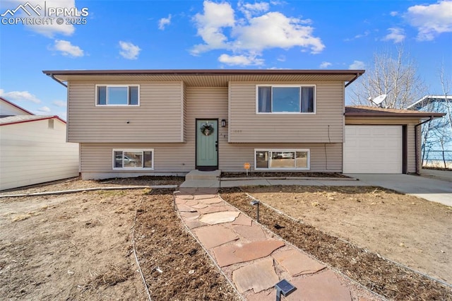 split foyer home with an attached garage and concrete driveway