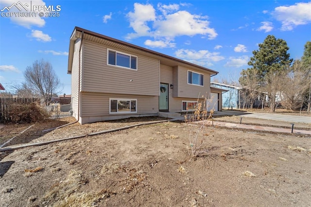 back of property with a garage