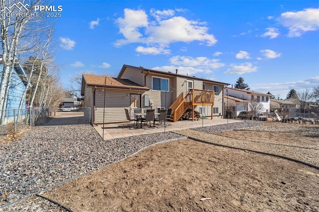 rear view of property with a patio and fence