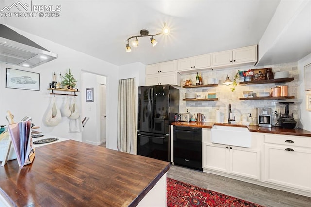 kitchen with black appliances, open shelves, a sink, and wooden counters