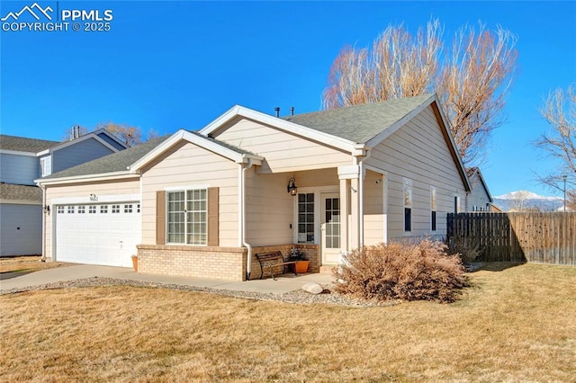 view of front of property featuring a garage, fence, a front lawn, and brick siding