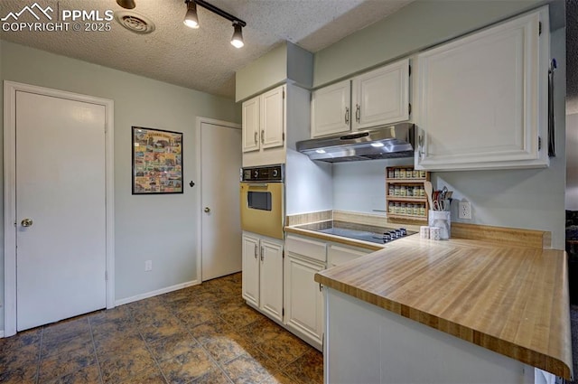 kitchen featuring white oven, white cabinetry, under cabinet range hood, and black electric cooktop