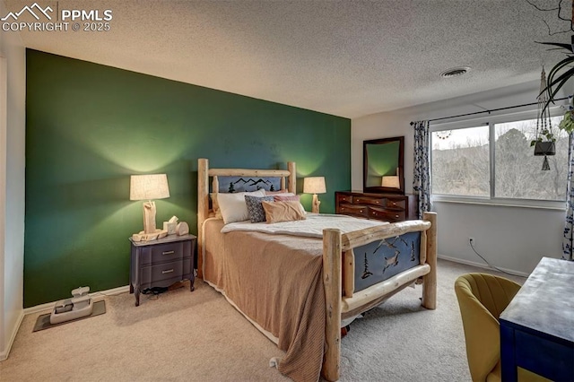 carpeted bedroom with baseboards, visible vents, and a textured ceiling