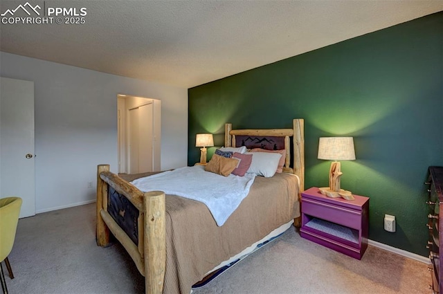 carpeted bedroom with a textured ceiling and baseboards