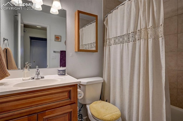 bathroom with toilet, vanity, and a shower with shower curtain